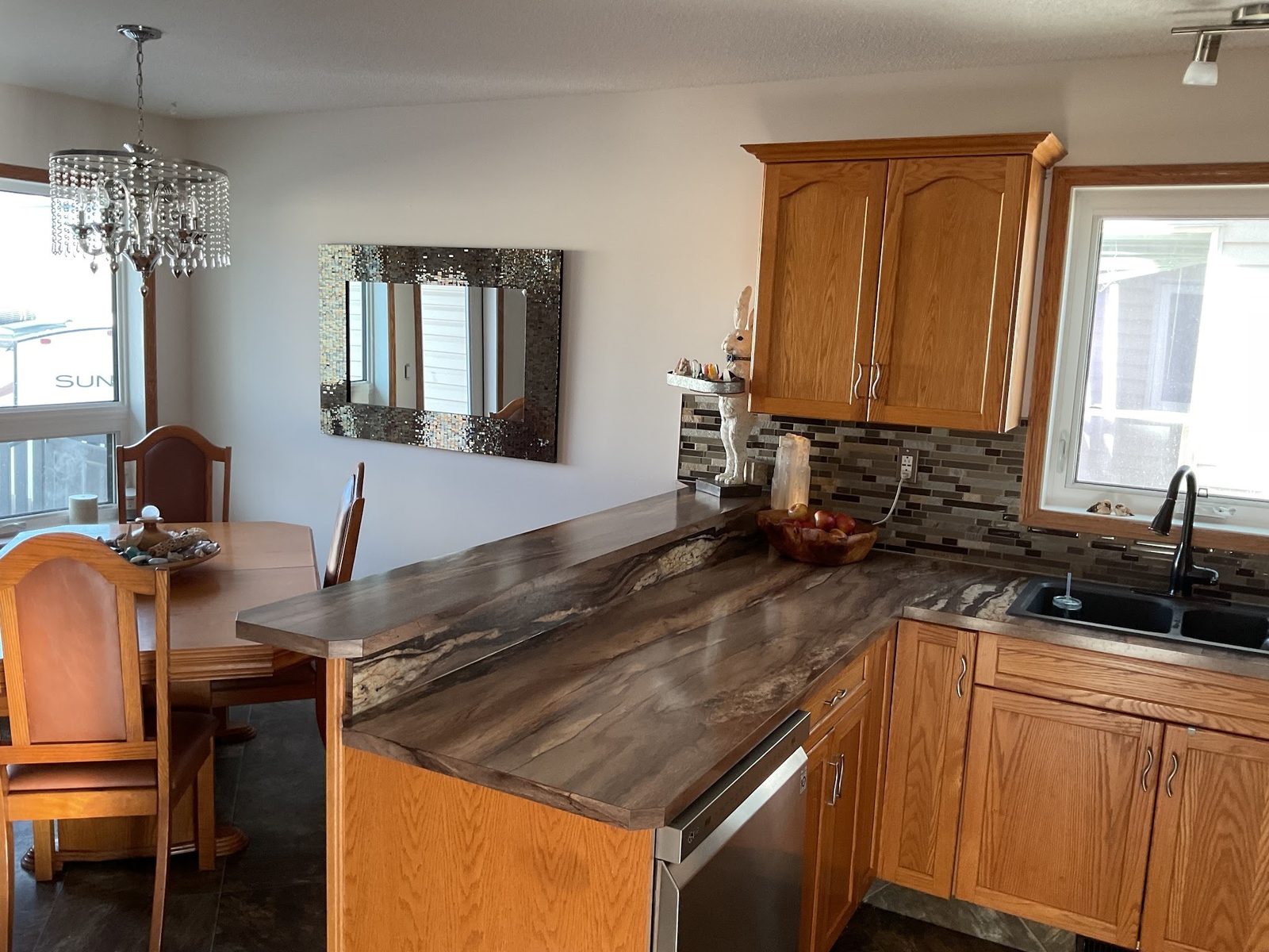Repainted kitchen walls beside original oak cabinets in a Red Deer home